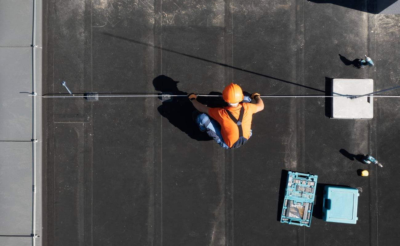 A person Learning How to Repair a Flat Roof Expert Tips and Step-by-Step Guide