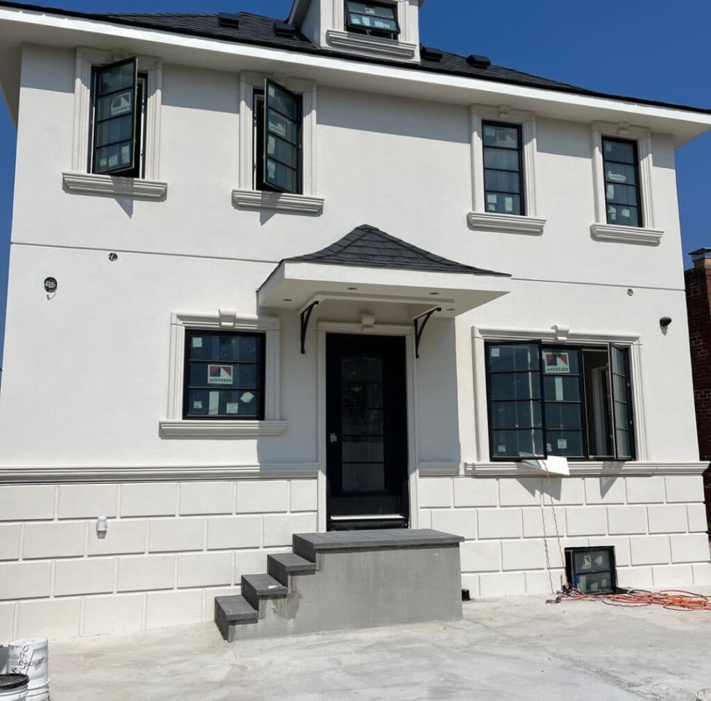 Stucco application on a Bushwick townhouse exterior