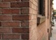 A detailed view of historic NYC brownstone brickwork showing professional maintenance and care.