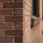 A detailed view of historic NYC brownstone brickwork showing professional maintenance and care.